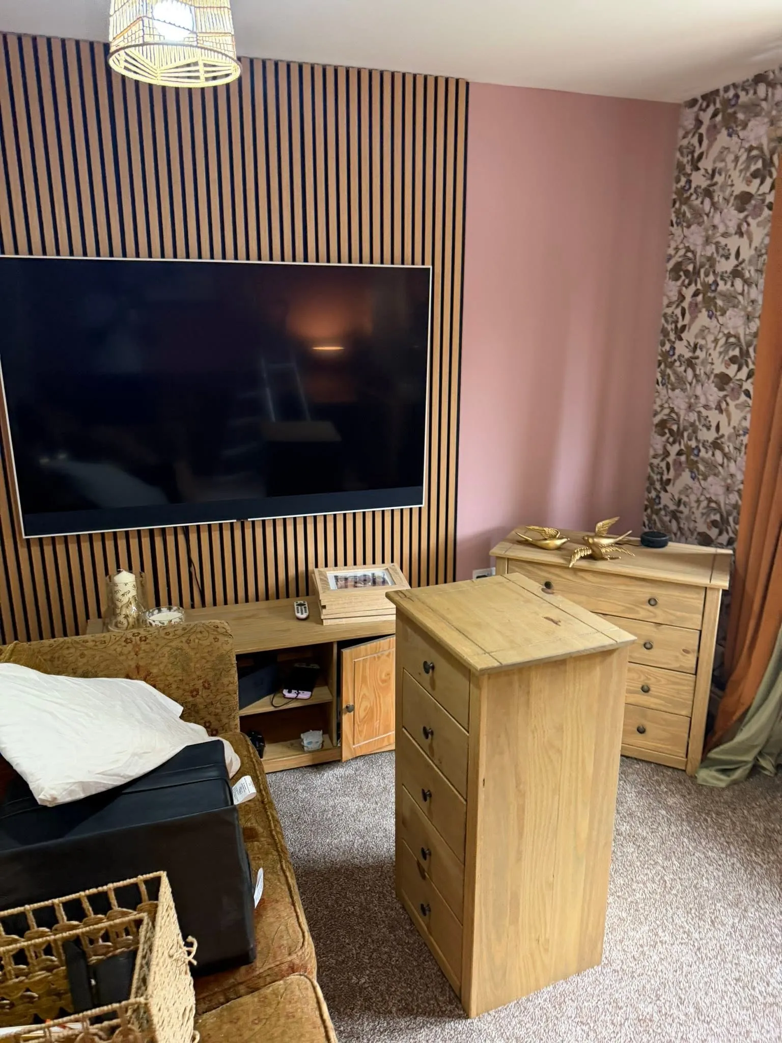 Living room with an oak slat feature wall behind a wall-mounted TV